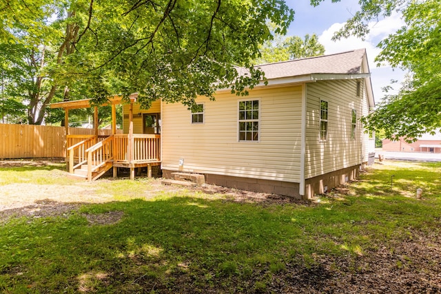 rear view of property featuring a shingled roof