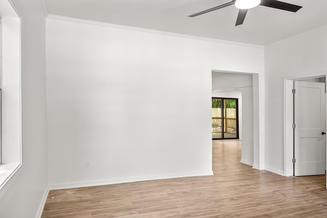empty room featuring ceiling fan, crown molding, light wood-style flooring, and baseboards
