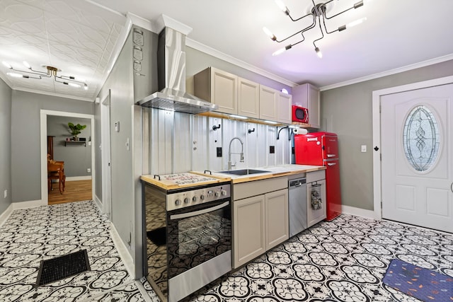 150 SE Fair St, Cleveland, TN 37311 - kitchen with stainless steel appliances, wall chimney range hood, a sink, ornamental molding, and a chandelier