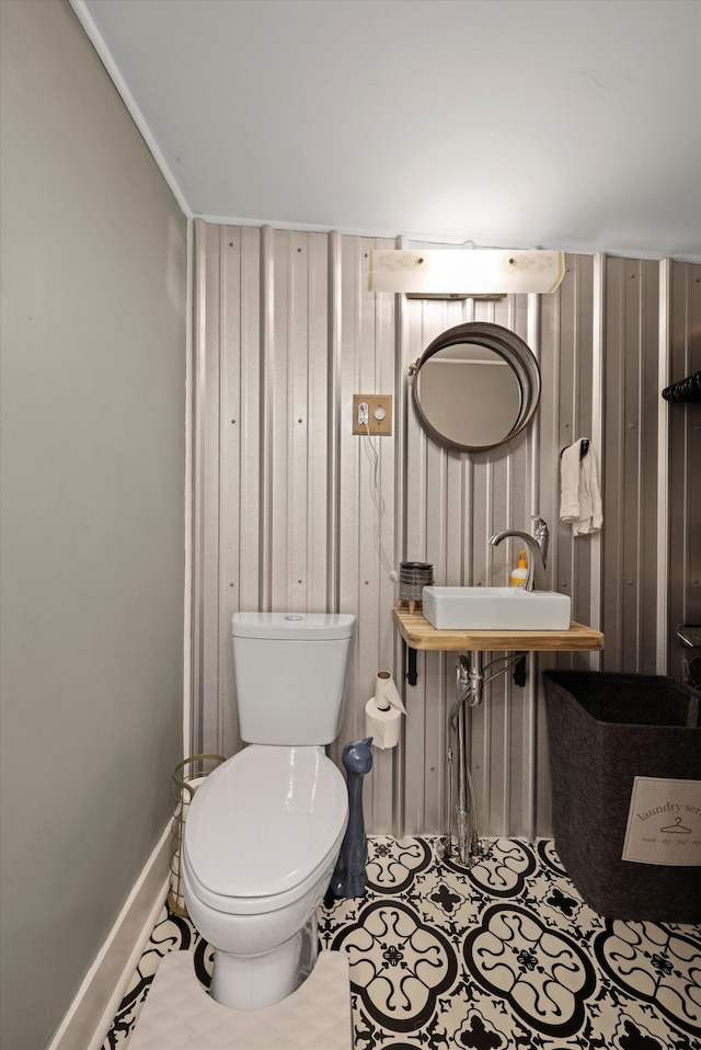 150 SE Fair St, Cleveland, TN 37311 - half bath with a sink, toilet, baseboards, and wood walls