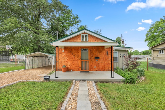 150 SE Fair St, Cleveland, TN 37311 - back of house featuring a carport, driveway, and covered porch