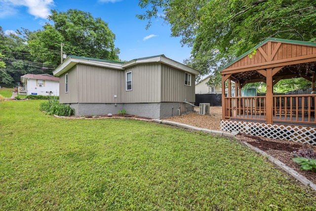 150 SE Fair St, Cleveland, TN 37311 - view of property exterior with central air condition unit, a lawn, a wooden deck, and a gazebo