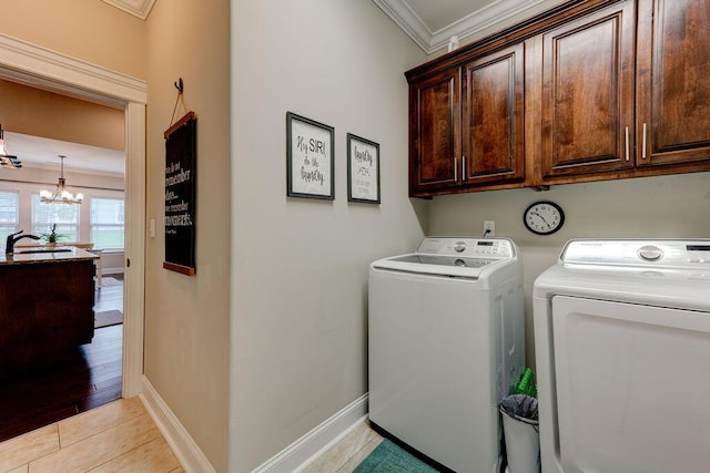 536 Live Oak Rd, Ringgold, GA 30736 - washroom featuring washer and dryer, ornamental molding, a chandelier, cabinet space, and baseboards