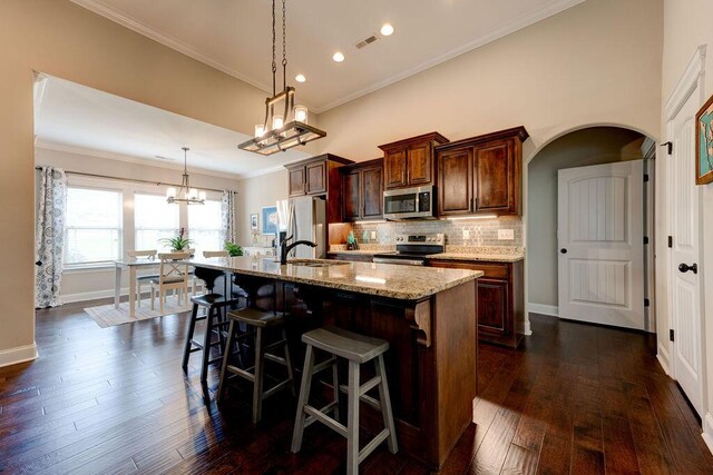 536 Live Oak Rd, Ringgold, GA 30736 - kitchen with stainless steel appliances, a chandelier, a center island with sink, baseboards, and decorative backsplash