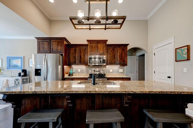 536 Live Oak Rd, Ringgold, GA 30736 - kitchen featuring stainless steel appliances, a sink, ornamental molding, arched walkways, and backsplash