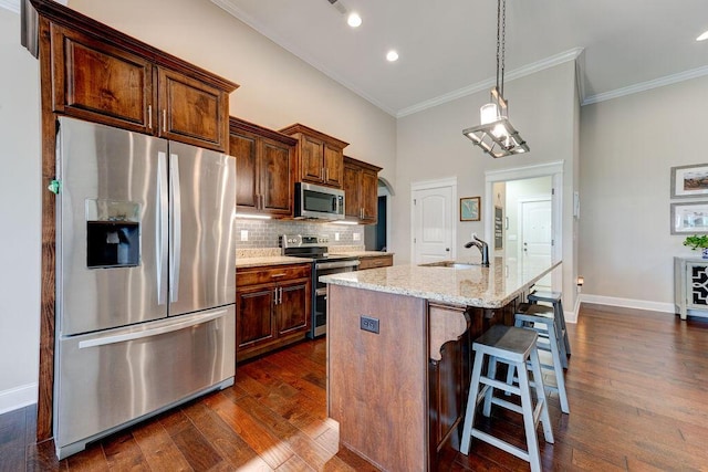 536 Live Oak Rd, Ringgold, GA 30736 - kitchen featuring appliances with stainless steel finishes, a sink, crown molding, tasteful backsplash, and arched walkways