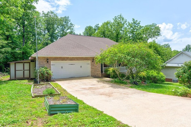 5040 Dellwood Dr, Rossville, GA 30741 - view of front of home with a vegetable garden, a front lawn, a garage, driveway, and a shed