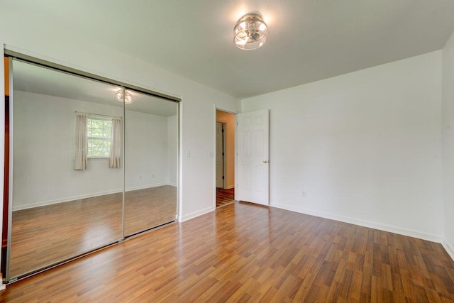 5040 Dellwood Dr, Rossville, GA 30741 - unfurnished bedroom featuring wood finished floors, a closet, and baseboards