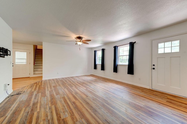 5040 Dellwood Dr, Rossville, GA 30741 - unfurnished living room with ceiling fan, stairs, light wood-style floors, a textured ceiling, and baseboards
