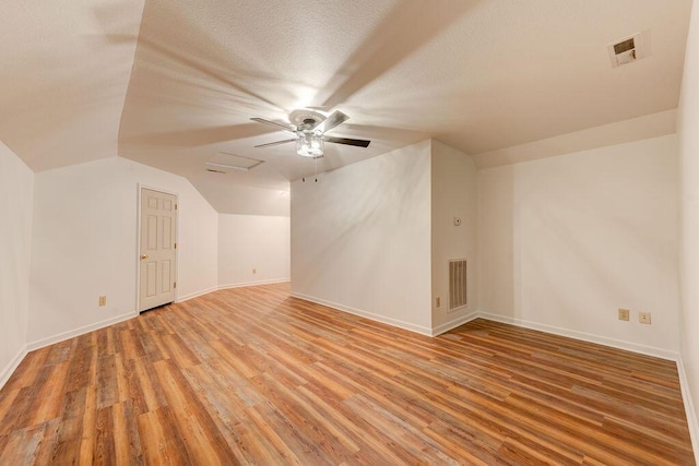5040 Dellwood Dr, Rossville, GA 30741 - bonus room featuring light wood-type flooring, a ceiling fan, vaulted ceiling, baseboards, and a textured ceiling