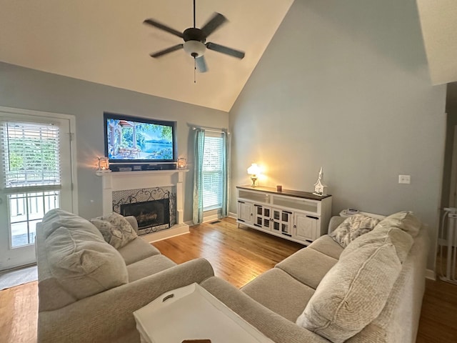 6180 Oilskin Dr, Ooltewah, TN 37363 - living area with ceiling fan, high vaulted ceiling, a stone fireplace, wood finished floors, and baseboards