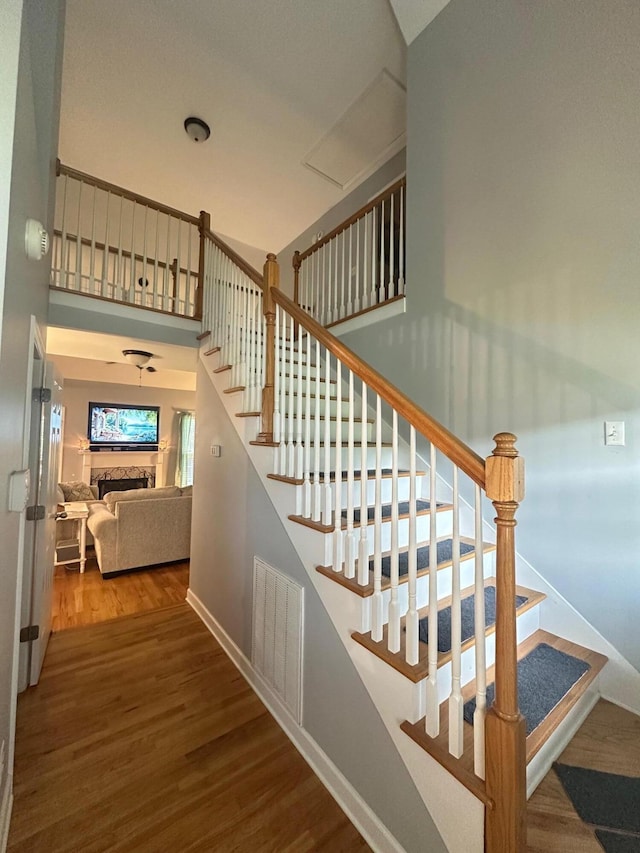 6180 Oilskin Dr, Ooltewah, TN 37363 - stairs featuring wood finished floors, a fireplace, and baseboards