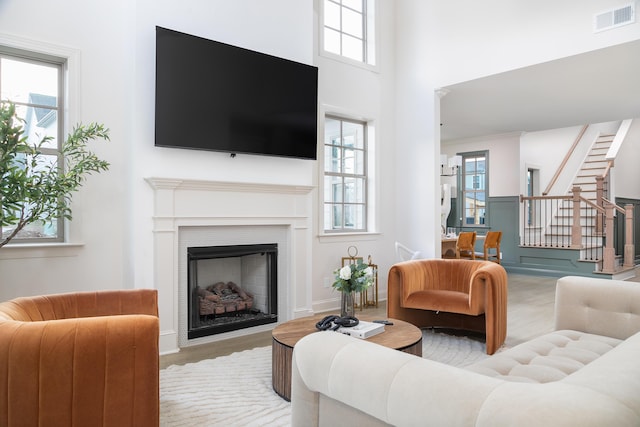 322 Fox Gap Ln, Hixson, TN 37343 - living area with stairway, a fireplace, healthy amount of natural light, and a towering ceiling
