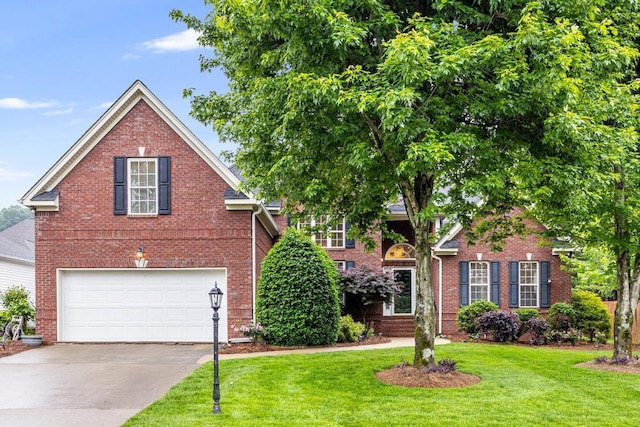 traditional-style house featuring a garage, a front yard, concrete driveway, and brick siding