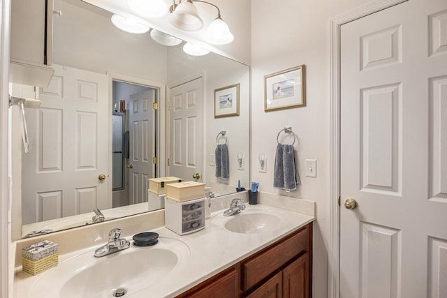 bathroom featuring double vanity and a chandelier