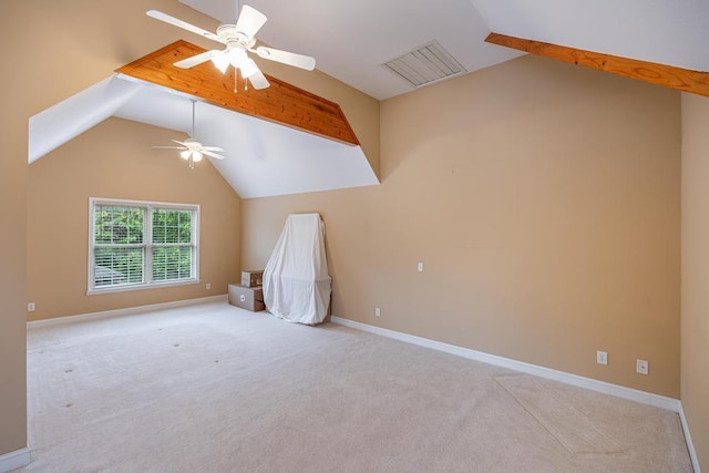 spare room featuring vaulted ceiling, a ceiling fan, carpet floors, and baseboards