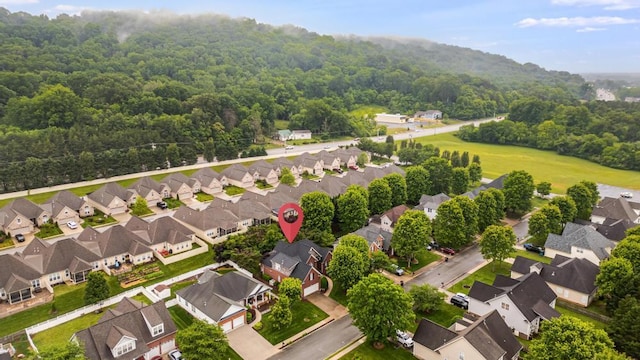 aerial perspective of suburban area with a heavily wooded area