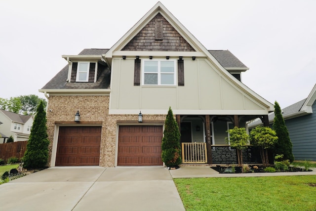 craftsman inspired home with driveway, board and batten siding, a garage, a porch, and a front lawn
