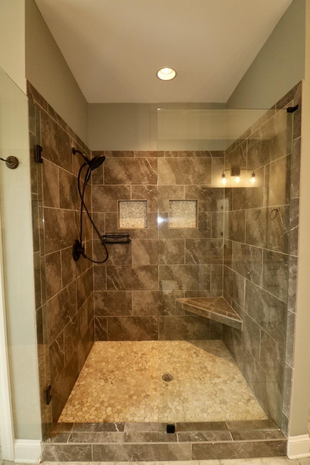 full bathroom featuring tiled shower and recessed lighting