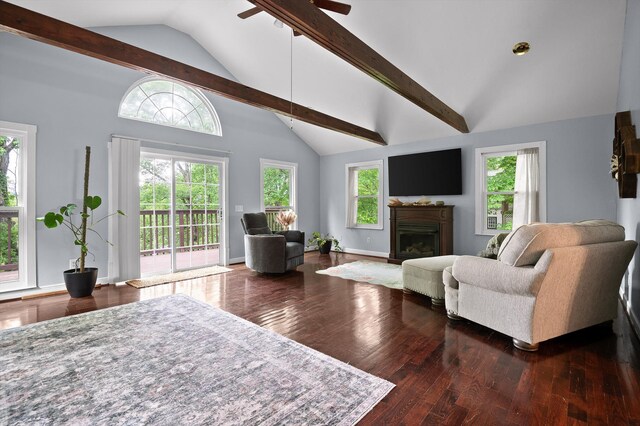 15033 Log Cabin Ln, Soddy Daisy, TN 37379 - living area featuring wood-type flooring, ceiling fan, a glass covered fireplace, beam ceiling, and high vaulted ceiling