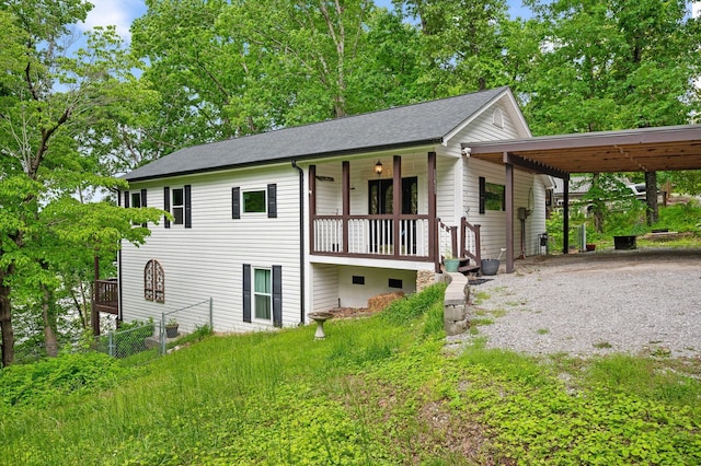 15033 Log Cabin Ln, Soddy Daisy, TN 37379 - view of front of home with gravel driveway, a carport, roof with shingles, fence, and covered porch