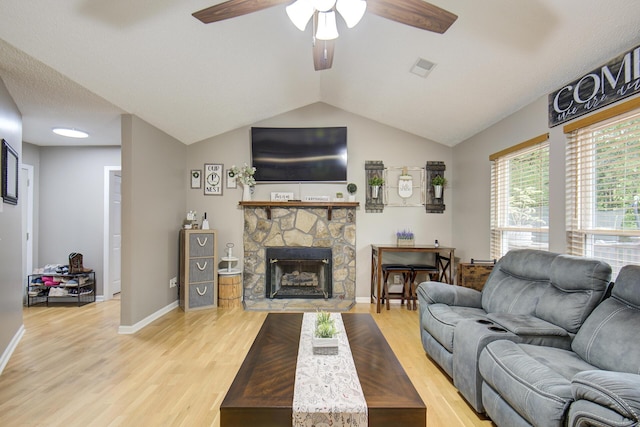 8820 Forest Pond Dr, Harrison, TN 37341 - living room featuring a ceiling fan, light wood-style flooring, baseboards, a fireplace, and vaulted ceiling