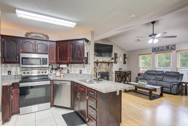 8820 Forest Pond Dr, Harrison, TN 37341 - kitchen with stainless steel appliances, a sink, a peninsula, a ceiling fan, and vaulted ceiling