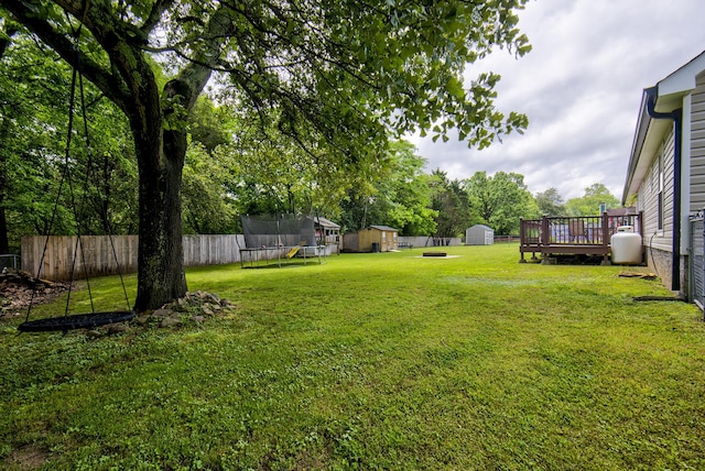 8820 Forest Pond Dr, Harrison, TN 37341 - view of yard with a storage unit, a trampoline, an outbuilding, and a deck