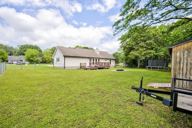 8820 Forest Pond Dr, Harrison, TN 37341 - view of yard featuring a wooden deck, a trampoline, and an outdoor fire pit
