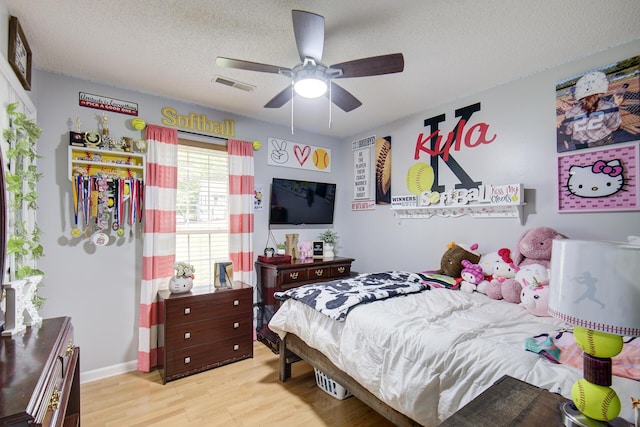 8820 Forest Pond Dr, Harrison, TN 37341 - bedroom with light wood-style flooring, a textured ceiling, ceiling fan, and baseboards