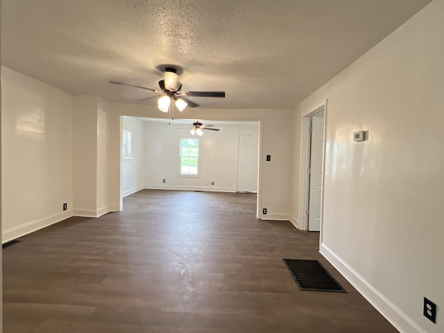 560 8th St NE, Cleveland, TN 37311 - unfurnished room with a ceiling fan, dark wood finished floors, a textured ceiling, and baseboards