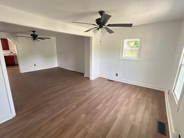 560 8th St NE, Cleveland, TN 37311 - empty room featuring ceiling fan, dark wood-style flooring, and baseboards