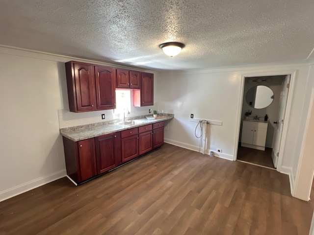 560 8th St NE, Cleveland, TN 37311 - kitchen featuring dark wood-style flooring, a sink, light countertops, a textured ceiling, and baseboards