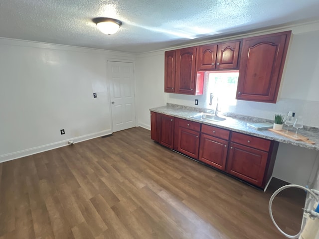 560 8th St NE, Cleveland, TN 37311 - kitchen featuring a sink, dark wood-style flooring, a textured ceiling, light stone counters, and baseboards