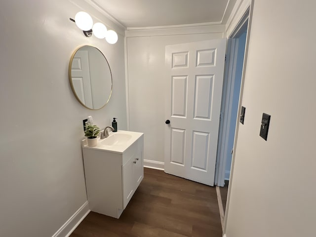 560 8th St NE, Cleveland, TN 37311 - bathroom with baseboards, wood finished floors, crown molding, and vanity