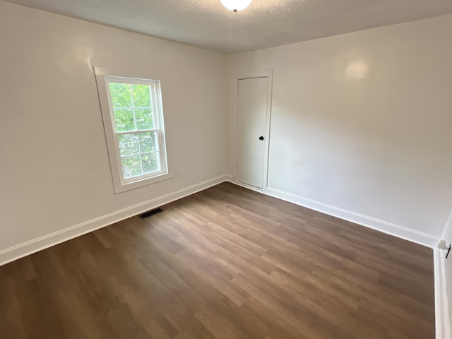 560 8th St NE, Cleveland, TN 37311 - spare room featuring dark wood finished floors and baseboards
