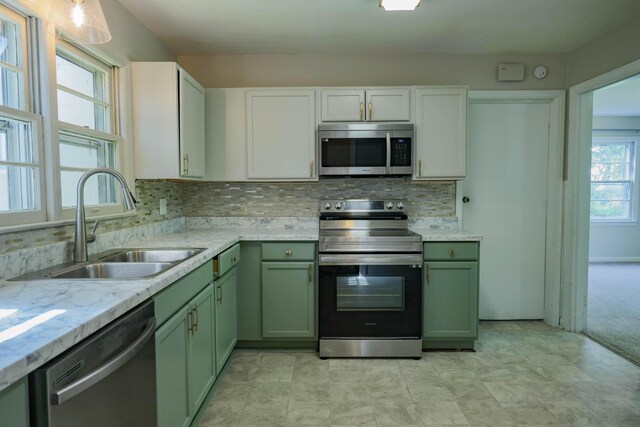 3703 Chula Vista Dr, Chattanooga, TN 37411 - kitchen featuring appliances with stainless steel finishes, green cabinets, a sink, and tasteful backsplash