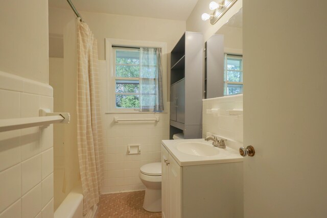 3703 Chula Vista Dr, Chattanooga, TN 37411 - bathroom with tile walls, toilet, vanity, shower / tub combo with curtain, and tile patterned floors