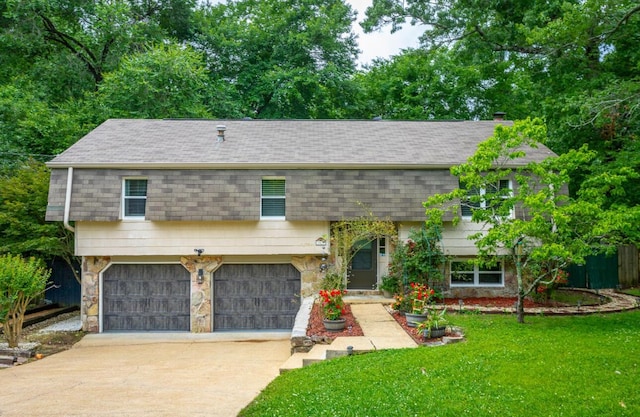 7429 Irongate Dr, Hixson, TN 37343 - view of property featuring driveway, a front yard, an attached garage, a shingled roof, and stone siding