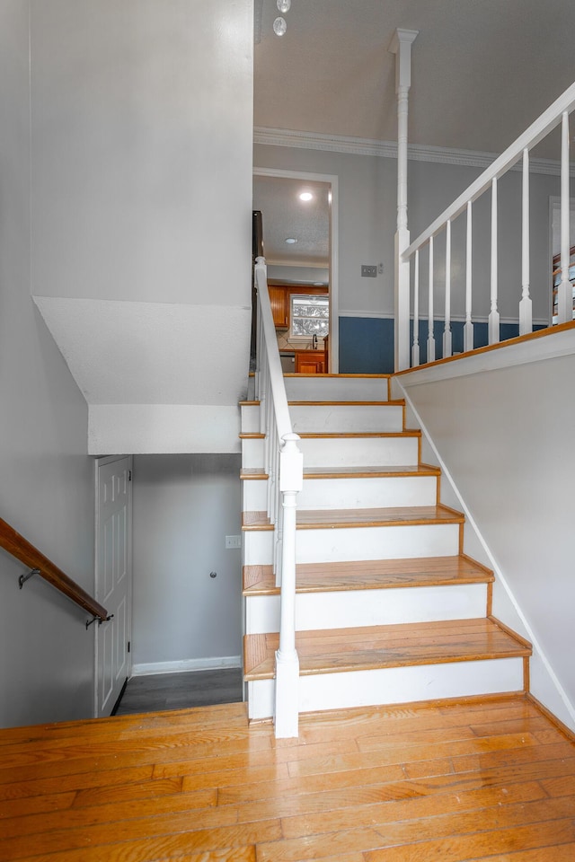7429 Irongate Dr, Hixson, TN 37343 - staircase featuring wood finished floors and crown molding