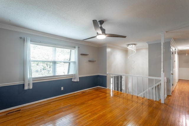 7429 Irongate Dr, Hixson, TN 37343 - unfurnished room featuring wood-type flooring, ornamental molding, attic access, ceiling fan, and a textured ceiling