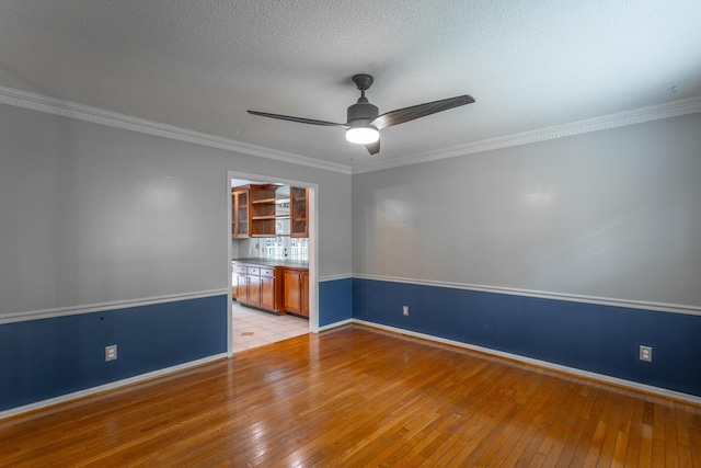 7429 Irongate Dr, Hixson, TN 37343 - empty room with light wood-style flooring, ceiling fan, baseboards, crown molding, and a textured ceiling