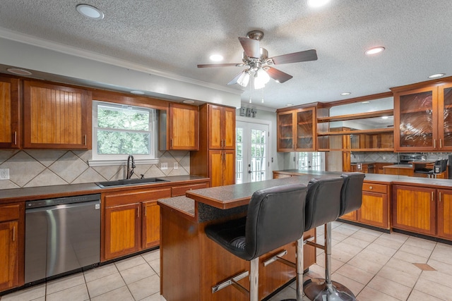 7429 Irongate Dr, Hixson, TN 37343 - kitchen with stainless steel dishwasher, a sink, ornamental molding, brown cabinets, and a textured ceiling