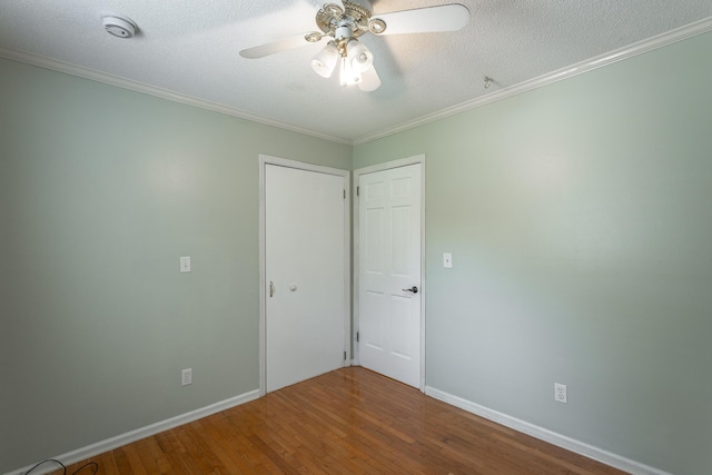 7429 Irongate Dr, Hixson, TN 37343 - unfurnished bedroom featuring wood finished floors, crown molding, a textured ceiling, baseboards, and a ceiling fan
