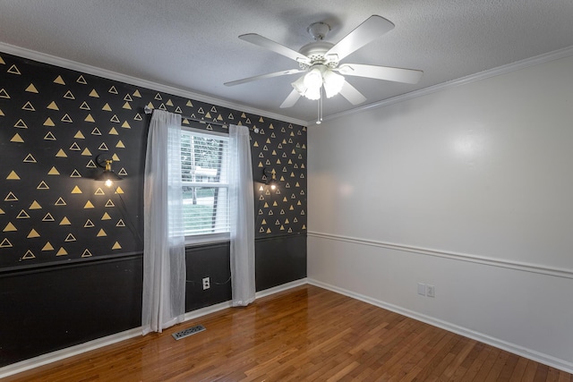 7429 Irongate Dr, Hixson, TN 37343 - spare room with crown molding, wood finished floors, a ceiling fan, wallpapered walls, and a textured ceiling