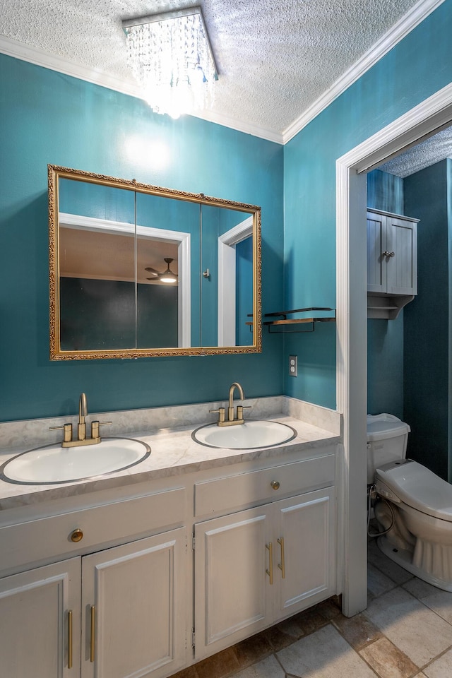 7429 Irongate Dr, Hixson, TN 37343 - bathroom with a textured ceiling, double vanity, toilet, and crown molding