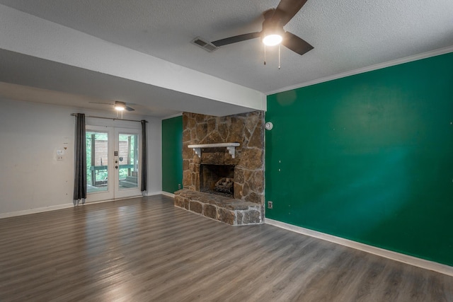 7429 Irongate Dr, Hixson, TN 37343 - unfurnished living room with a ceiling fan, wood finished floors, a textured ceiling, baseboards, and a stone fireplace