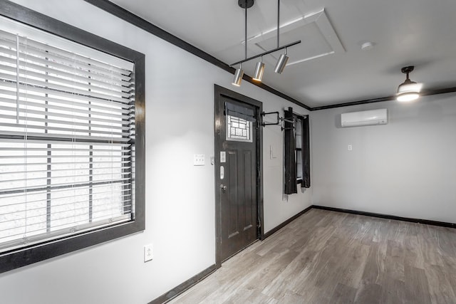 7429 Irongate Dr, Hixson, TN 37343 - spare room featuring a wall mounted AC, light wood finished floors, baseboards, crown molding, and a smoke detector