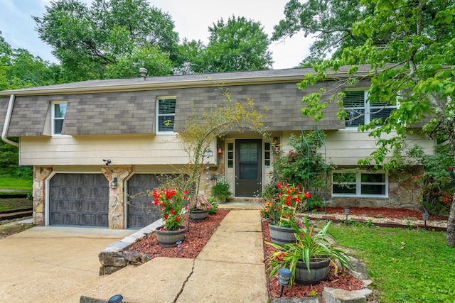 7429 Irongate Dr, Hixson, TN 37343 - view of front of property with driveway, an attached garage, a shingled roof, and stone siding