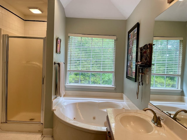 full bathroom featuring a jetted tub, a shower stall, and vanity